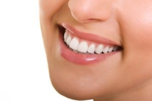 Beautiful smile of a young woman on white background